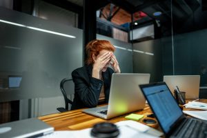 Worried businesswoman working using laptop at office