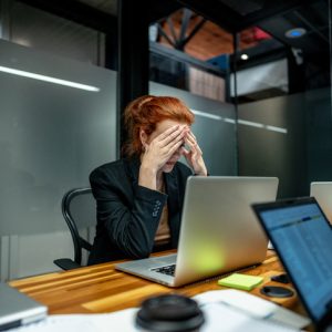 Worried businesswoman working using laptop at office